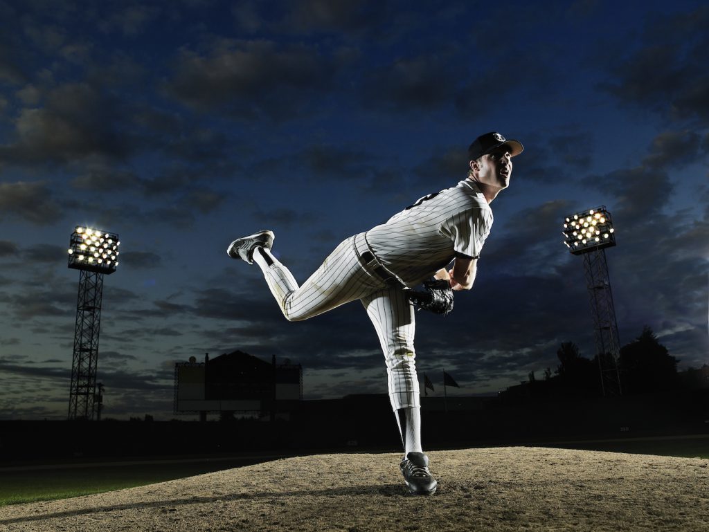 Baseball player pitching off mound
